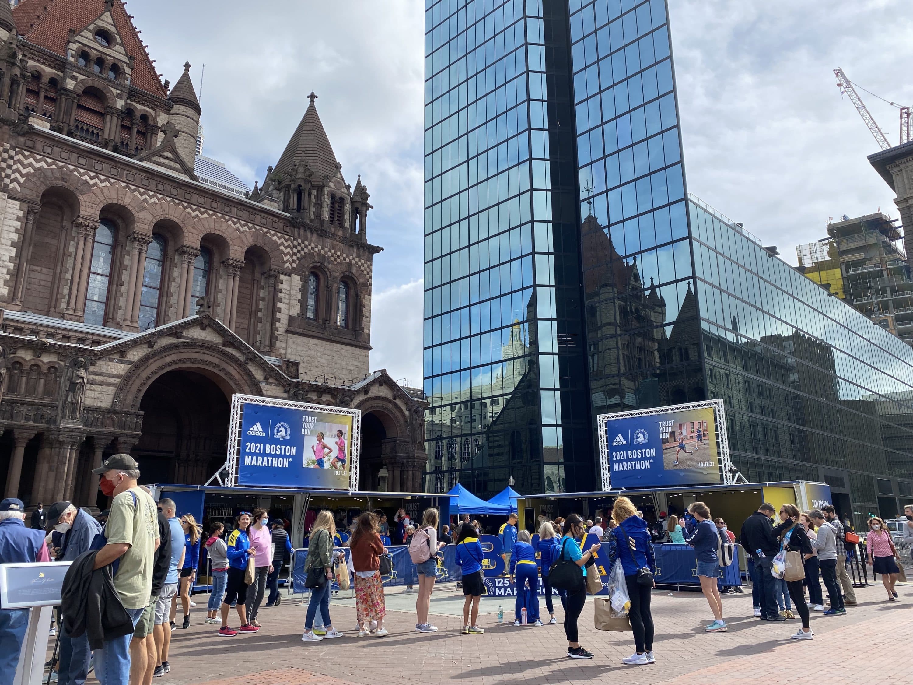 Runners of the 2021 Boston Marathon pick up their jackets and explore Copley Square the weekend before race day. (Amanda Beland/WBUR)