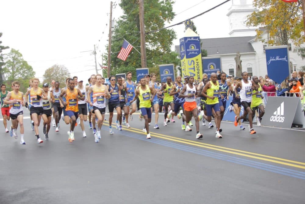 The elite men's division crossing the starting line in Hopkinton during the 2021 Boston Marathon. (Robin Lubbock/WBUR)