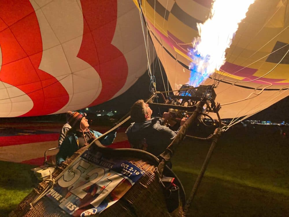 Members of the Albuquerque Balloon Fiesta’s Dawn Patrol inflate their balloons ahead of the morning’s first launch. (Peter O'Dowd/Here & Now)
