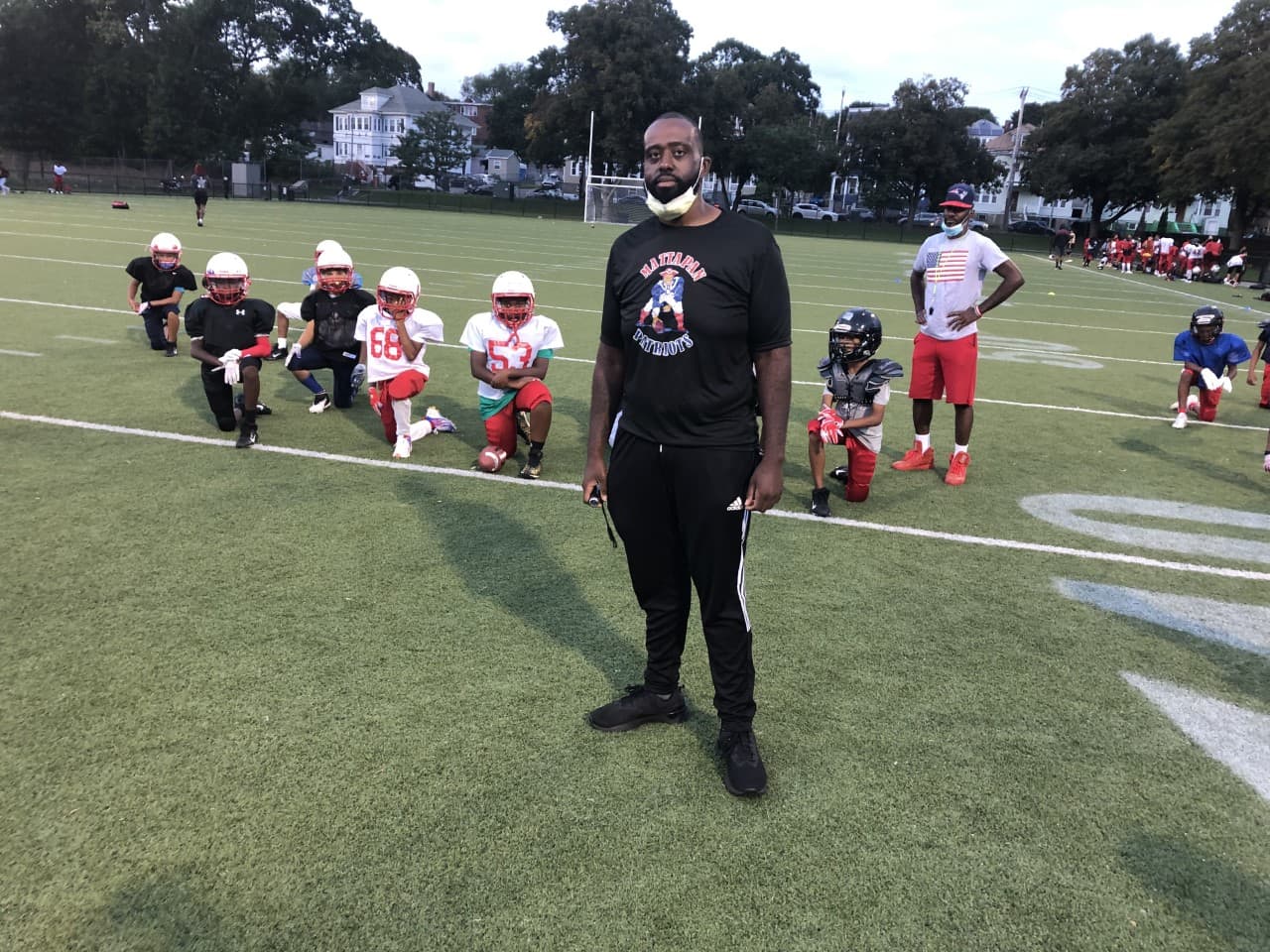 Mick Brunache, quien entrena un equipo de fútbol Pop Warner en Mattapan. (Anthony Brooks / WBUR)