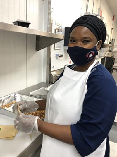 Chef Mariama bagging nuts. (Karyn Miller-Medzon/Here & Now)