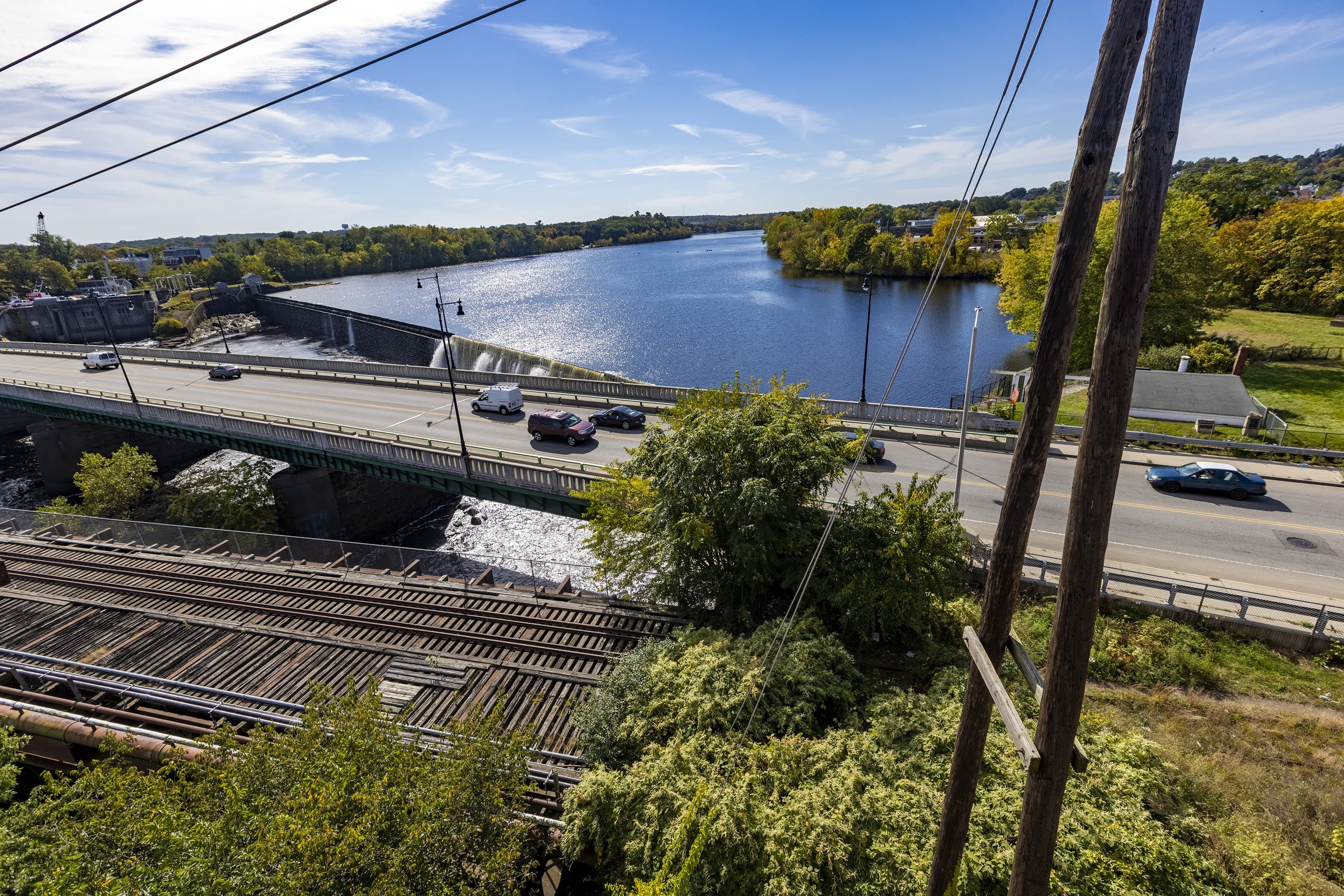 The Merrimack River runs over the Great Stone Dam and underneath Broadway in Lawrence. (Jesse Costa/WBUR)