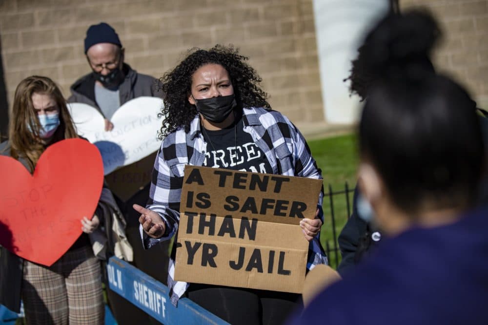 Community activist Jasmin Borges of the Mass Bail Fund, speaks with Suffolk County District Attorney Rachael Rollins during her visit to Suffolk County House of Corrections to view the facility on its first day processing people arrested near "Mass. and Cass" on outstanding warrants. (Jesse Costa/WBUR)