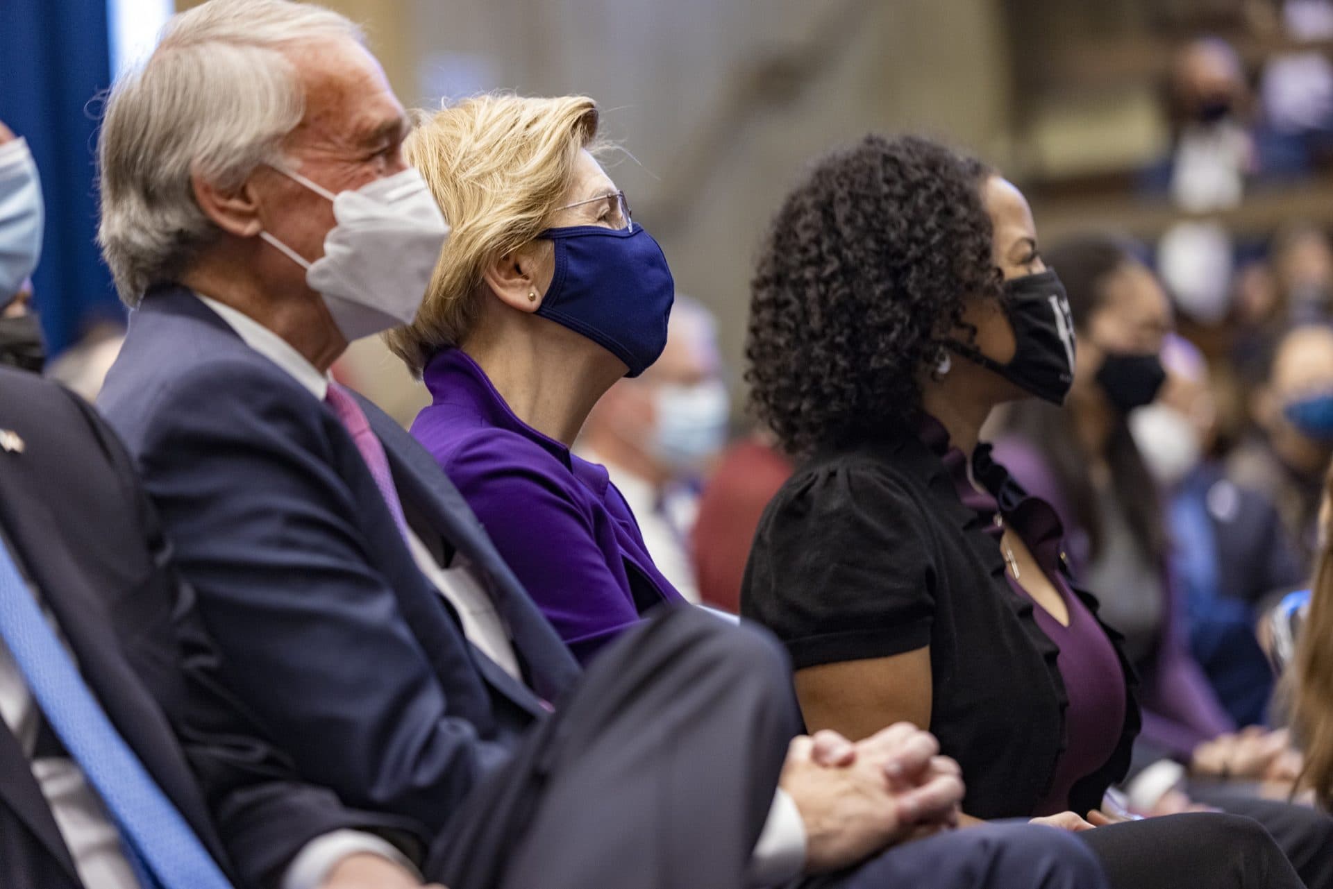 U.S. Sens. Edward Markey and Elizabeth Warren and former Mayor Kim Janey listen as Mayor Michelle Wu speaks. (Jesse Costa/WBUR)