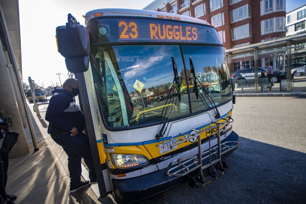 Riders board the 23 Ruggles bus at Ashmont Station, one of the three bus routes included in the expansion plans for fare-free bus service in Boston. (Jesse Costa/WBUR)