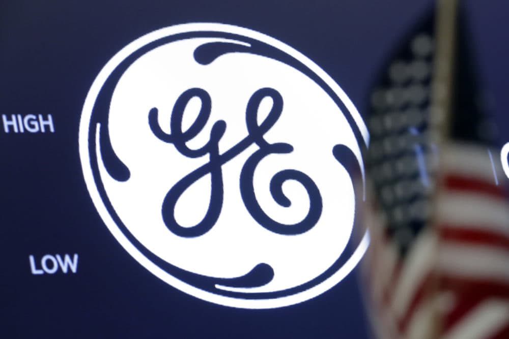 The General Electric logo appears above a trading post on the floor of the New York Stock Exchange, June 26, 2018. General Electric is splitting itself into three public companies that concentrate on aviation, health care and energy. (Richard Drew/AP File)