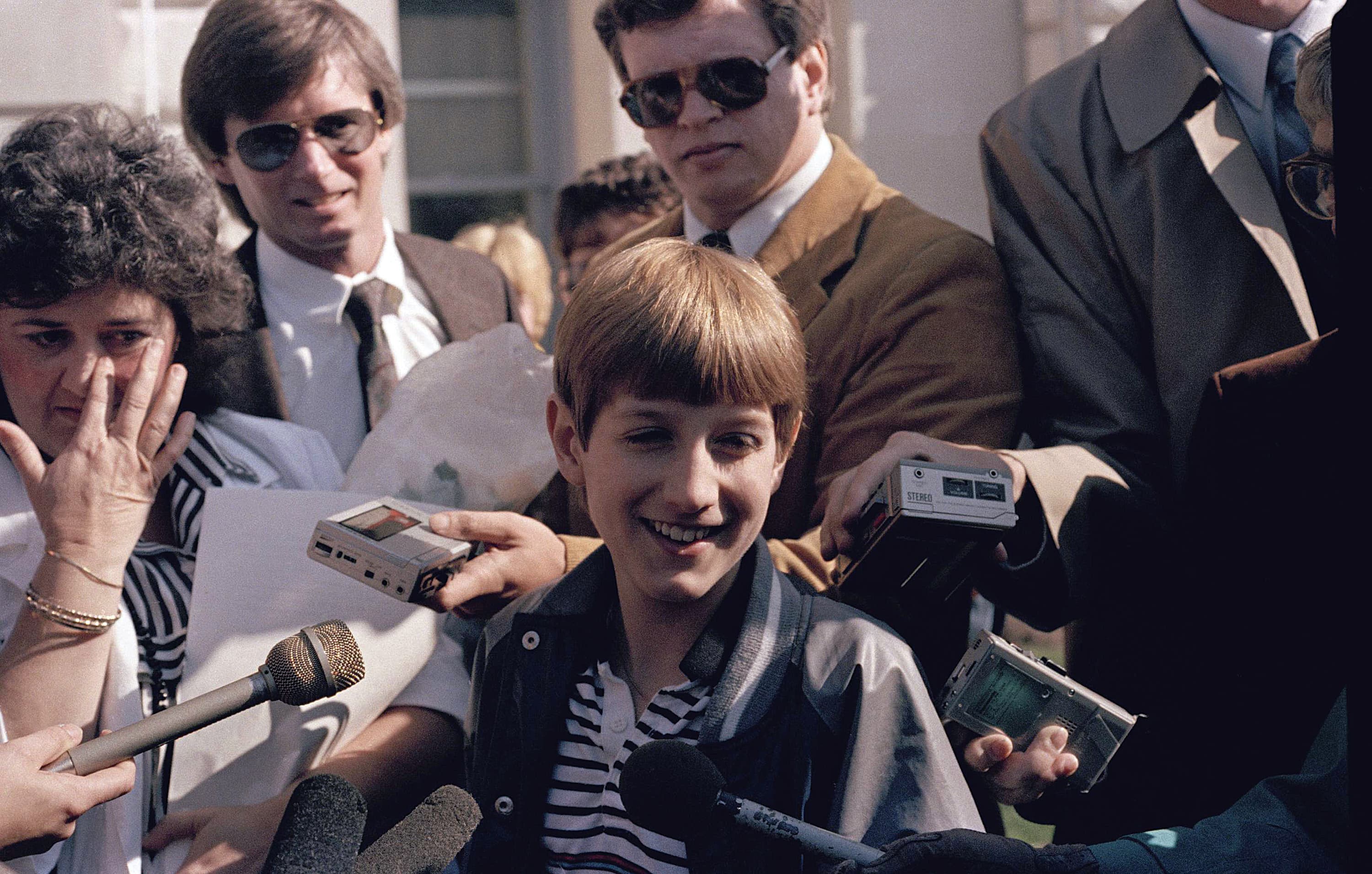 Teenage AIDS patient Ryan White is surrounded by friends and reporters after a judge threw out a temporary injunction barring him from attending classes at Western Middle School near Kokomo, Ind., April 10, 1986. Ryan's mother Jeanne is at left and attorney Charles V. Vaughn is at rear. (AP Photo)