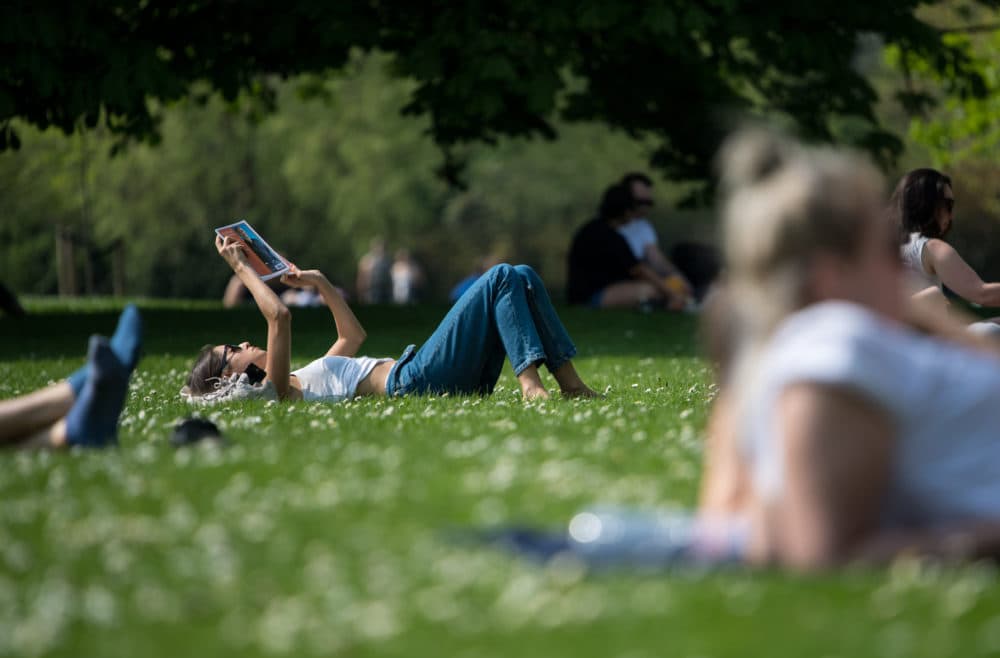 A woman reads a book in Hyde Park in London, United Kingdom. (Chris J Ratcliffe/Getty Images)