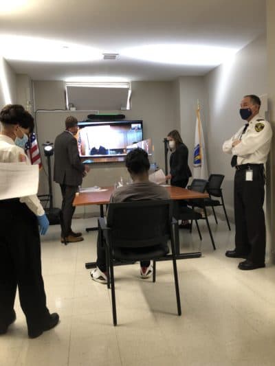 A defendant appears before a remote judge during a special court session held in the Suffolk County jail. (Deborah Becker/WBUR)