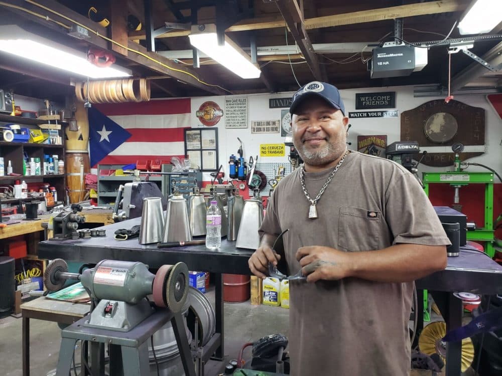 Ulisis Santiago in his garage shop. (Maayan Silver/WUWM)