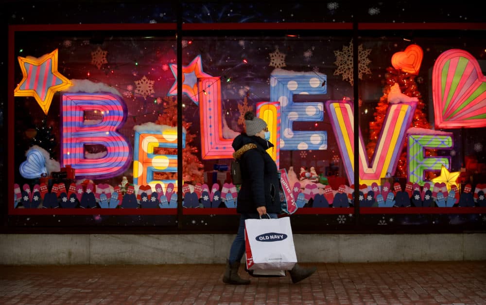 A shopper passed a Macy's store holiday window in Downtown Crossing in Boston in December 2020. (Craig F. Walker/The Boston Globe via Getty Images)