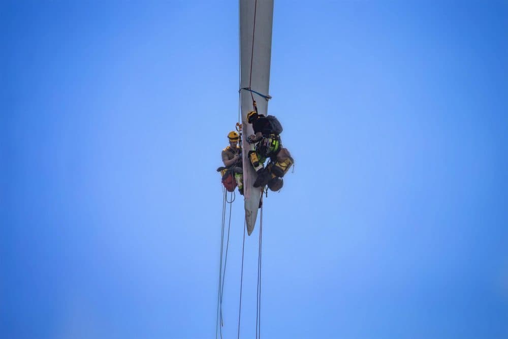 Technicians repair a turbine blade at the Block Island Wind Farm, (Jesse Costa/WBUR)