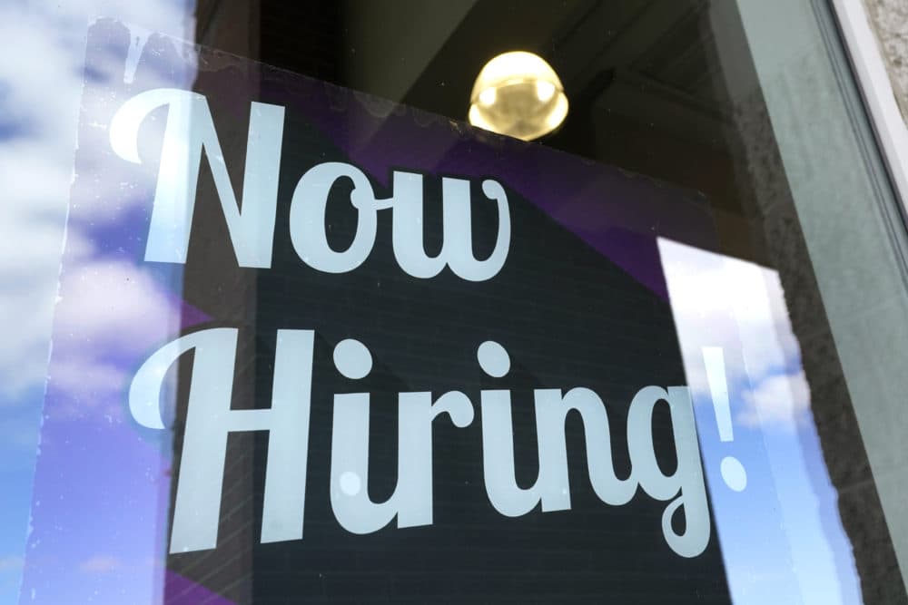 A "Now Hiring" sign is displayed on a business window, Thursday, March 4, 2021, in Salem, N.H. (AP Photo/Elise Amendola)
