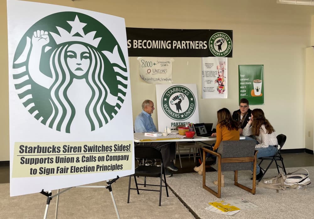 Richard Bensinger, left, who is advising unionization efforts, along with baristas Casey Moore, right, Brian Murray, second from left, and Jaz Brisack, second from right, discuss their efforts to unionize three Buffalo-area stores, inside the movements headquarters on Thursday, Oct. 28, 2021 in Buffalo, N.Y. (Carolyn Thompson/AP)