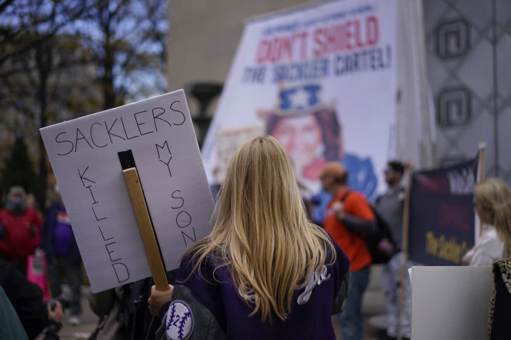 Jen Trejo from California holds a sign that reads "SACKLERS KILLED MY SON" during a protest with other advocates for opioid victims outside the Department of Justice, Dec. 3, 2021, in Washington. (Carolyn Kaster/AP)