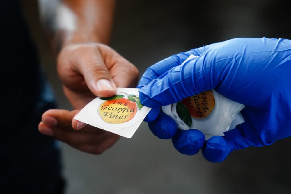 A man receives an "I'm a Georgia Voter" sticker after casting a ballot in Georgia's primary election on June 9, 2020, in Atlanta, Georgia. (Elijah Nouvelage/Getty Images)