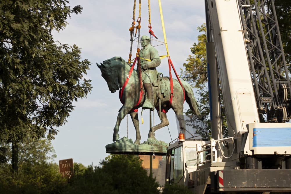 Workers remove the statue of Confederate General Robert E. Lee from a park in Charlottesville, Virginia on July 10, 2021. (Ryan M. Kelly/AFP via Getty Images)