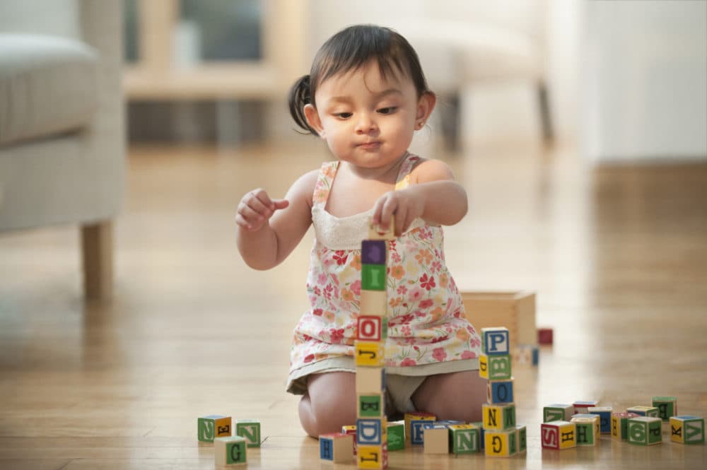 A baby playing with blocks. (Getty Images)