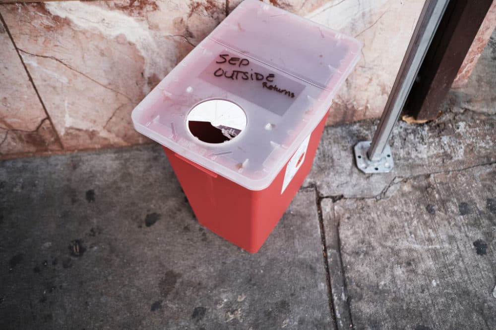 A bin for dirty needles sits outside of an East Harlem health clinic that provides free needles and other services to drug users on Dec. 1, 2021 in New York City. New York Mayor Bill de Blasio has announced that New York City has opened two overdose prevention centers, the first supervised injection sites for drug users in the nation. (Spencer Platt/Getty Images)