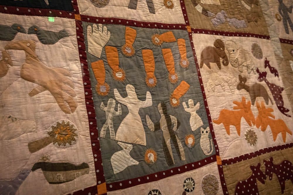 Detail from Harriet Powers' Pictorial Quilt (1895-98). This panel is believed to depict the Leonid meteor storm of 1833. From Powers' description of the quilt: "The falling of the stars on Nov. 13, 1833. The people were frightened and thought that the end had come. God's hand staid the stars. The varmints rushed out of their beds." (Robin Lubbock/WBUR)