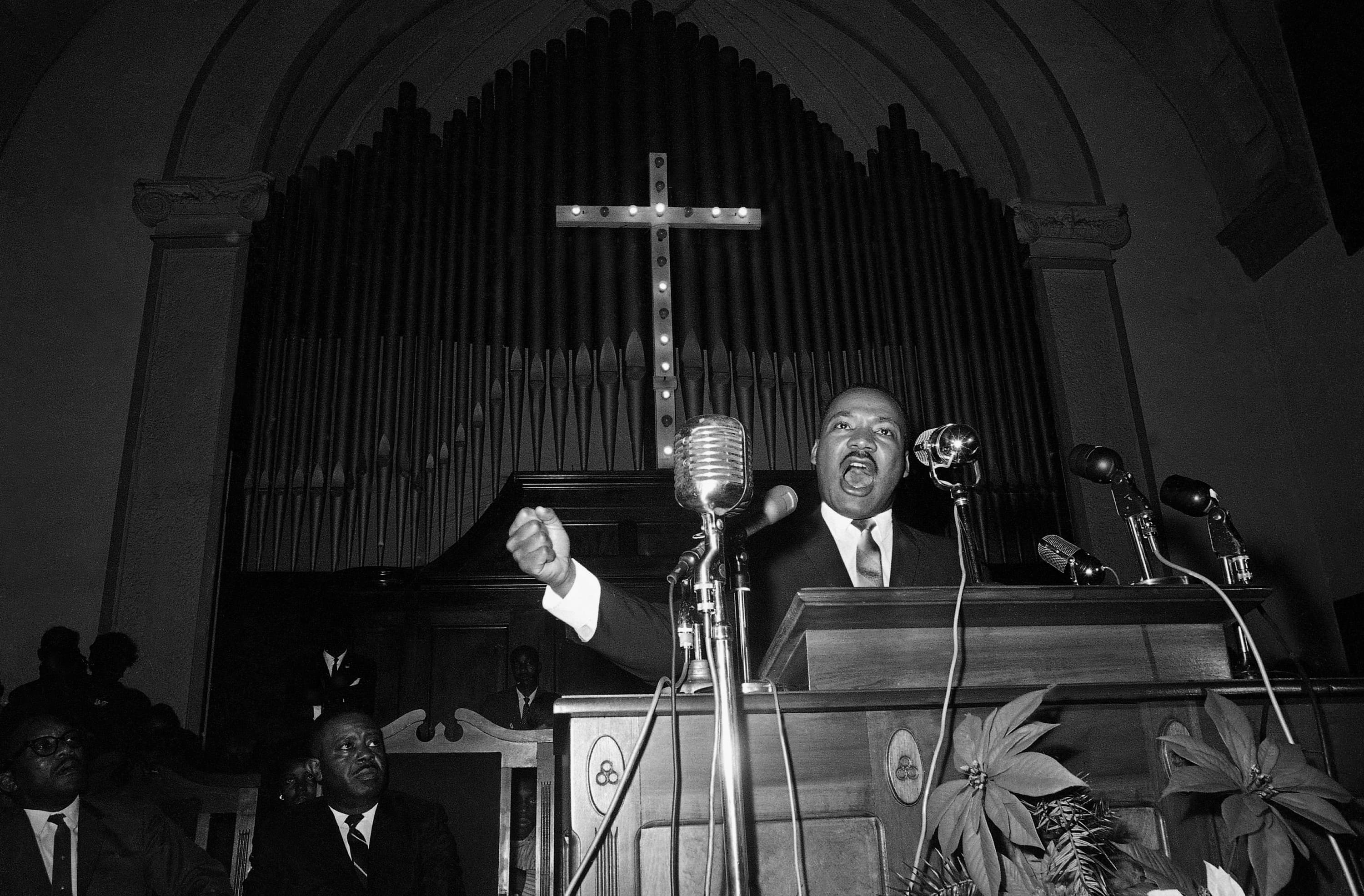 Martin Luther King Jr. speaks to a wildly cheering crowd of  supporters on Jan. 2, 1965, in Selma, Ala. King was calling for a new voter registration drive throughout Alabama and promising to "march on the ballot boxes" unless African American are given the right to vote. (Horace Cort/AP)
