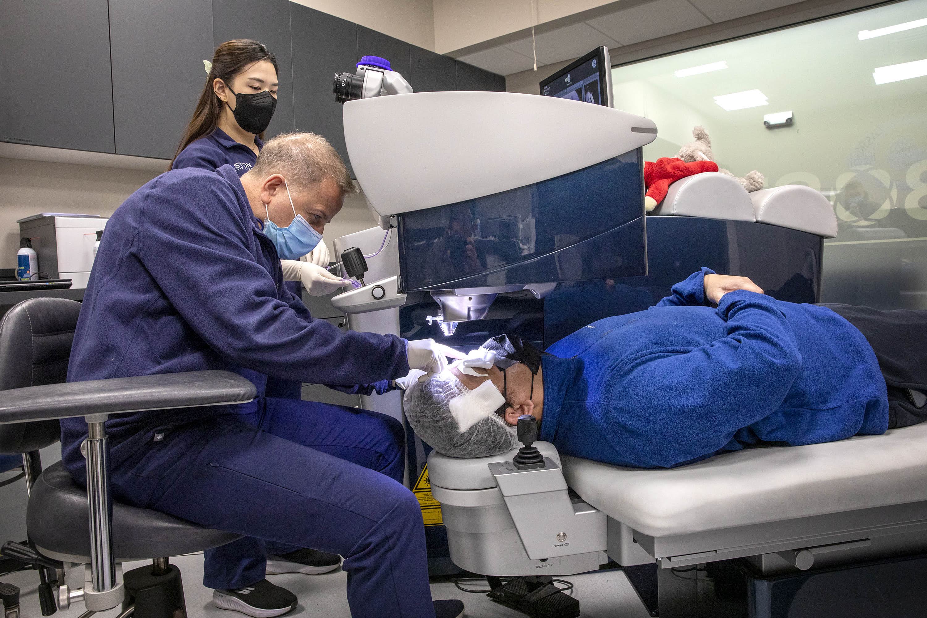 Dr. Samir Melki at work during a LASIK corrective eye surgery operation. (Robin Lubbock/WBUR)