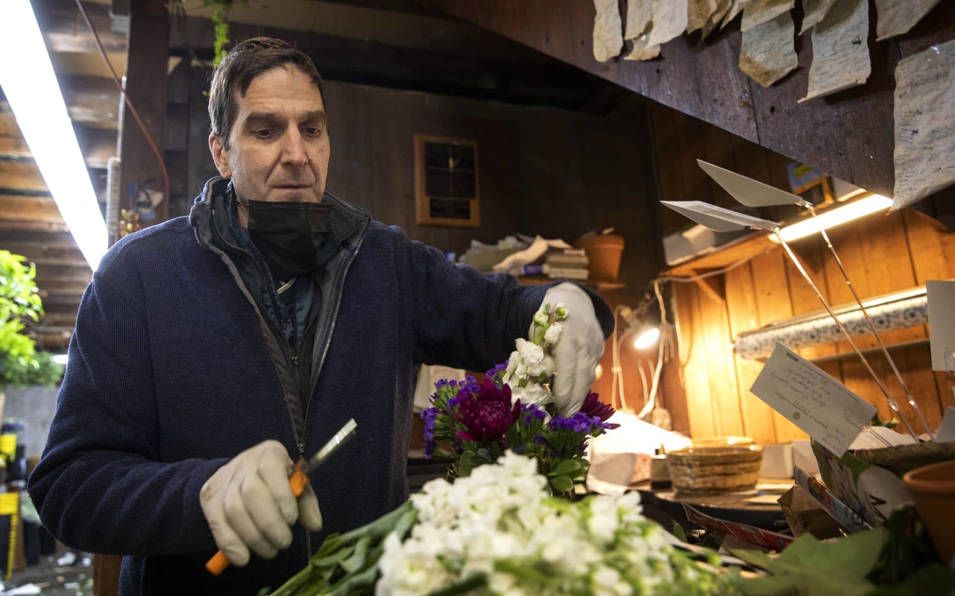 Stephen Zedros, the longtime manager of Brattle Square Florist, creates a flower arrangement.  (Robin Lubbock/WBUR)