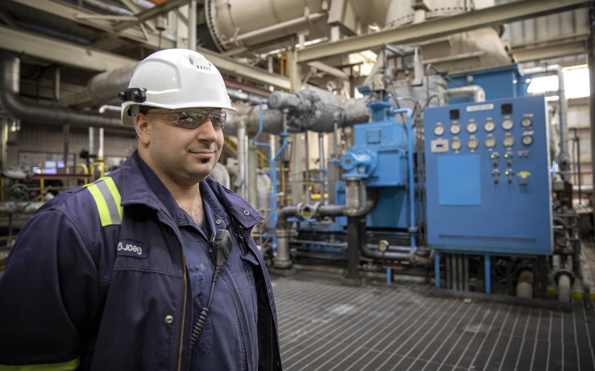 Operations manager George Bakas by the generator at Covanta's waste burning facility in Haverhill. (Robin Lubboock/WBUR)