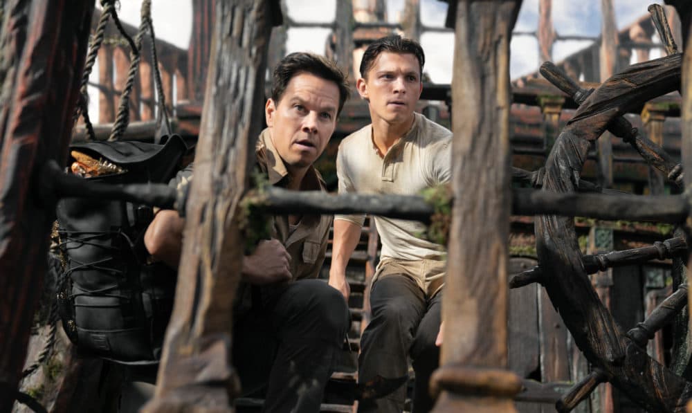 Victor "Sully" Sullivan (Mark Wahlberg, left) and Nathan Drake (Tom Holland) look to make their move in "Uncharted." (Clay Enos/Sony Pictures)