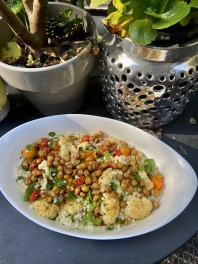 Roasted cauliflower and cherry tomatoes with Israeli couscous and crispy spicy chickpeas.  (Kathy Gunst / Here & Now)
