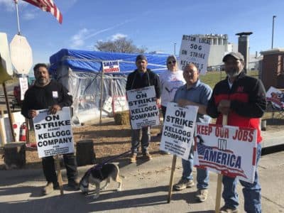 Striking Kellogg's workers Michael Rodarte, Sue Griffin, Michael Elliott, Eric Bates and Mark Gonzalez stand outside the Omaha, Neb., cereal plant on, Dec. 2, 2021. (AP Photo/Josh Funk)