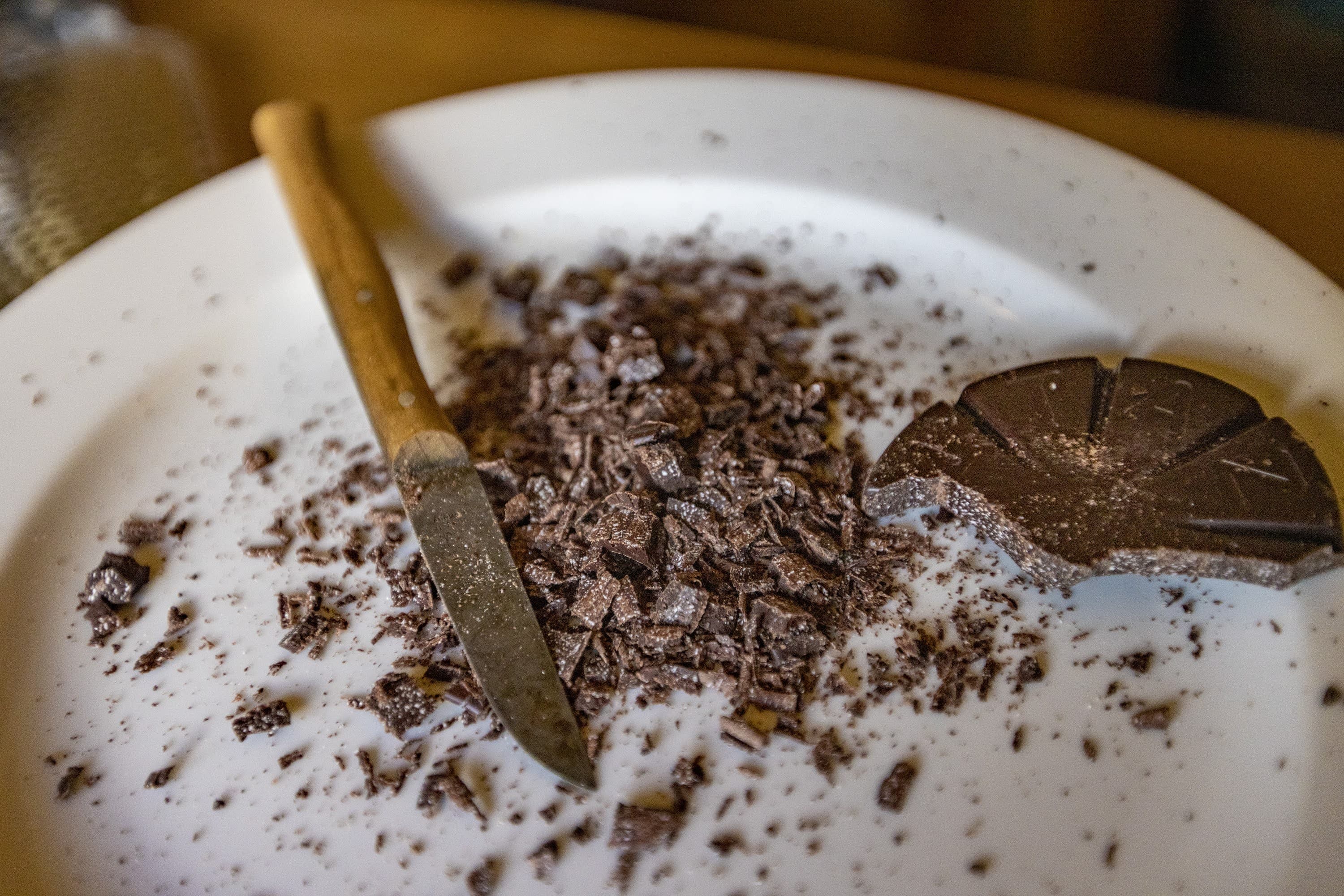 The chocolate tablet from Taza Chocolate in Somerville is shaved using a knife, just as it would have been done in many colonial households. (Jesse Costa/WBUR)