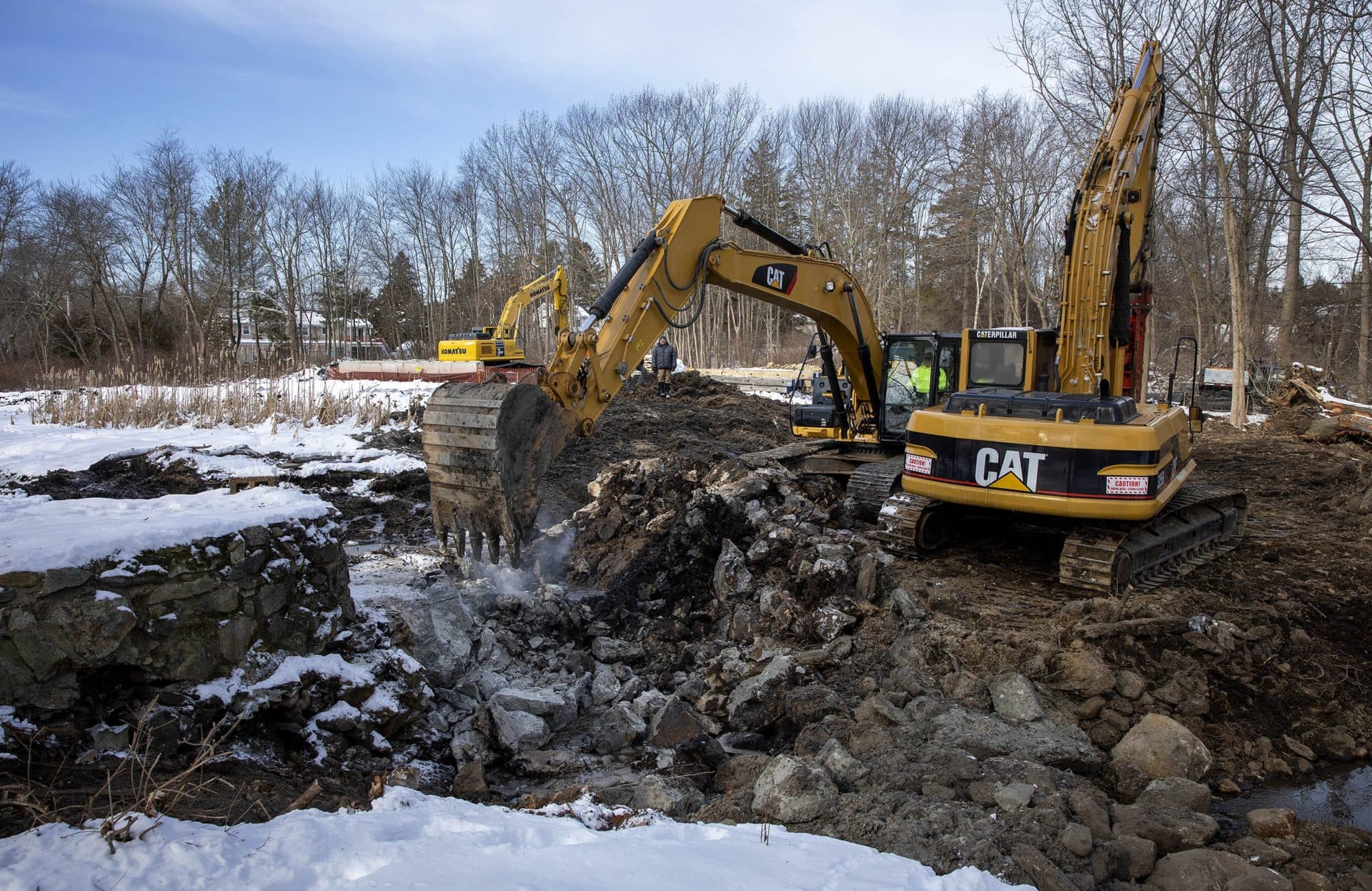A digger removes rubble that once held back the water on Traphole Brook. (Robin Lubbock/WBUR)