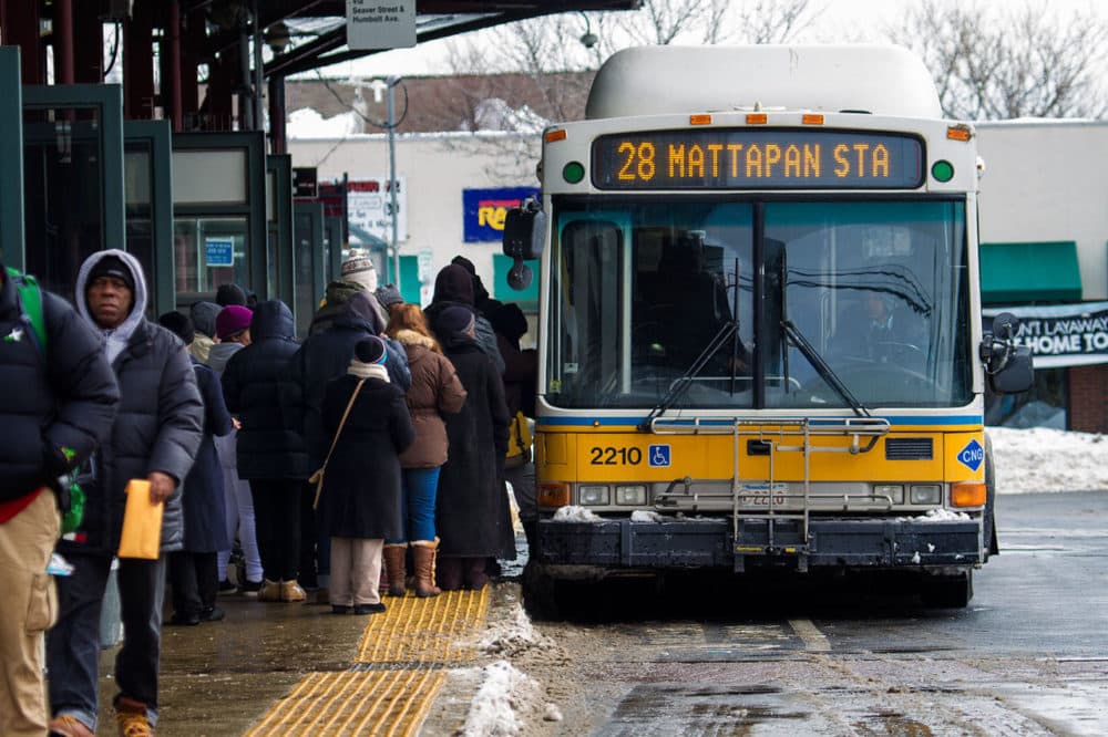 Commuters board an MBTA bus.  (Jesse Costa/WBUR)