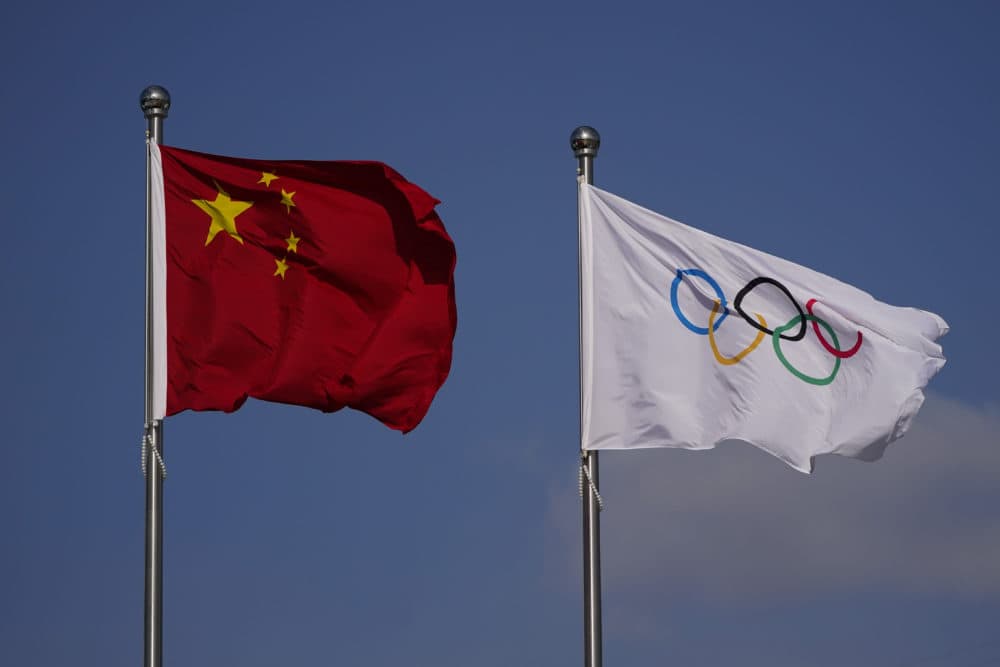 The Olympic and Chinese flags flutter in the wind ahead of the 2022 Winter Olympics, Monday, Jan. 31, 2022, in Beijing. (Jae C. Hong/AP)