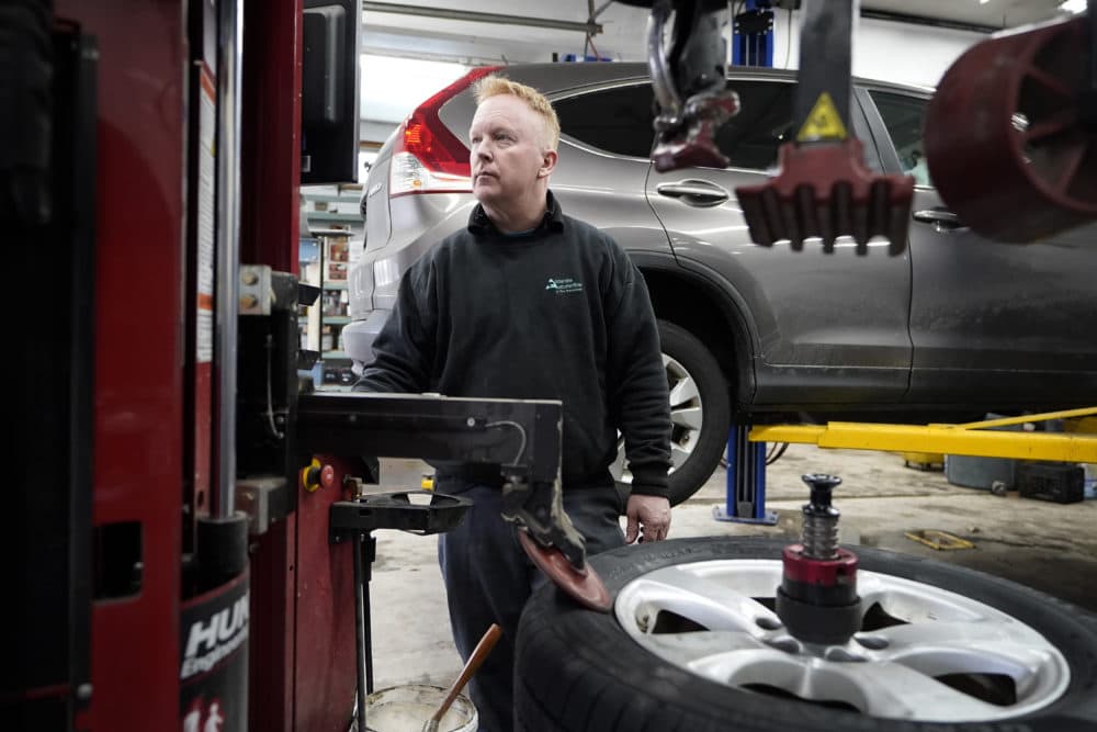 Brian Hohmann, mechanic and owner of Accurate Automotive, uses a tire changing machine in his workshop.  He said most independent repairers are perfectly able to compete with dealers on both repair skills and price, as long as they have the information and software access they need.  (Steven Senne/AP)