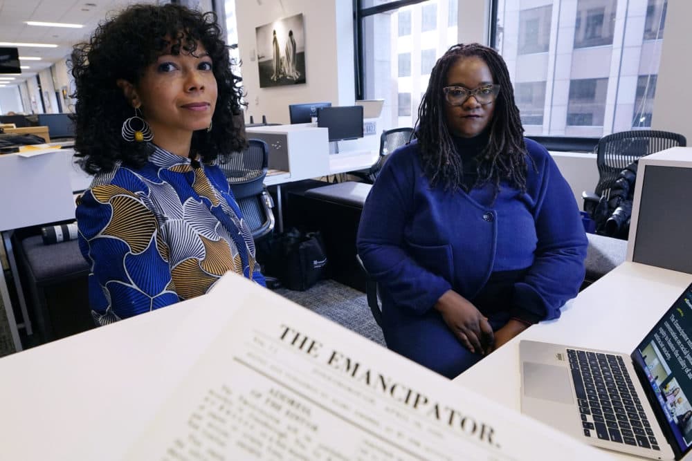Amber Payne, left, and Deborah Douglas, co-editors-in-chief of the new online publication of &quot;The Emancipator,&quot; pose at their office inside the Boston Globe, Feb. 2, 2022, in Boston. (AP Photo/Charles Krupa)