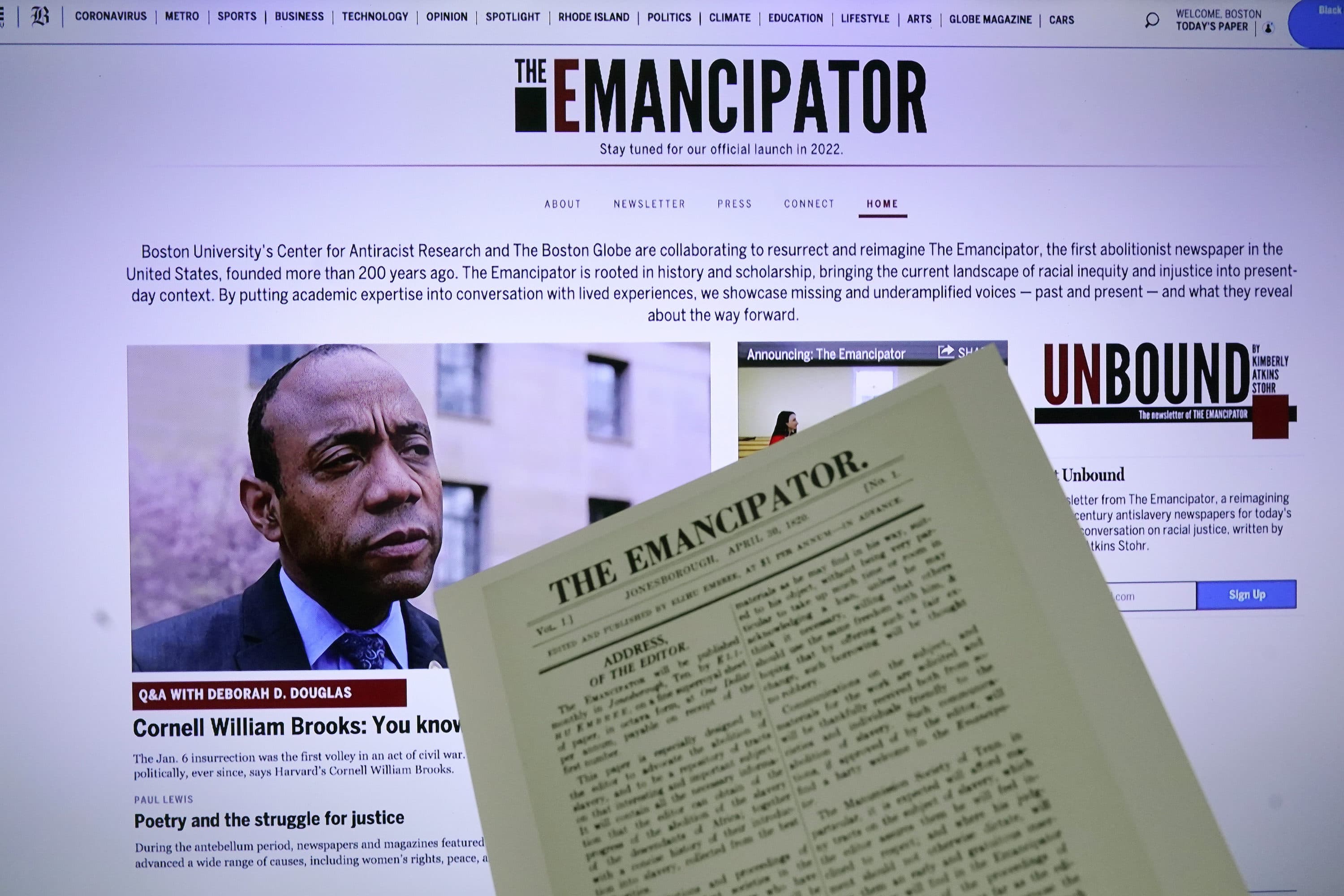 The new online publication of "The Emancipator" is pictured with a copy of the April 30, 1820, first edition of "The Emancipator", Feb. 2, 2022, in Boston. (AP Photo/Charles Krupa)
