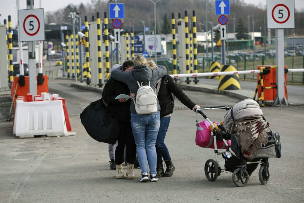 Family members hug as they reunite, after fleeing conflict in Ukraine, at the Medyka border crossing, in Poland, Sunday, Feb. 27, 2022. (AVisar Kryeziu/AP)
