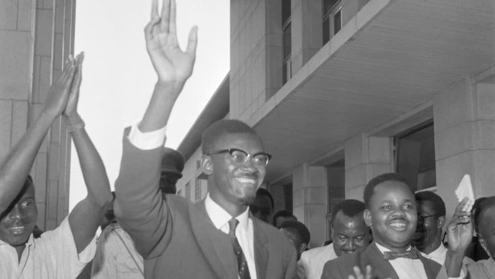 Leopoldville, Congo. Flushed with victory, Congolese Premier Patrice Lumumba waves as he leaves the National Senate. Lumumba had just received a 41-2 vote of confidence. (Bettmann/Getty Images)