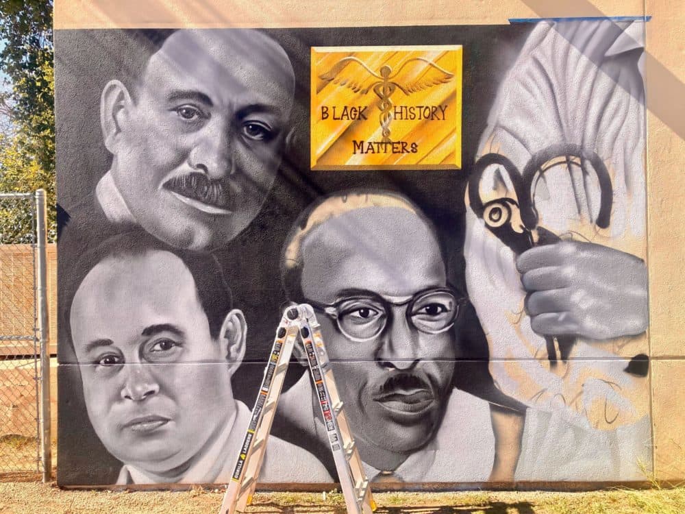 This mural by Giovannie Dixon depicts three pioneering Black doctors. (Peter O'Dowd/Here & Now)