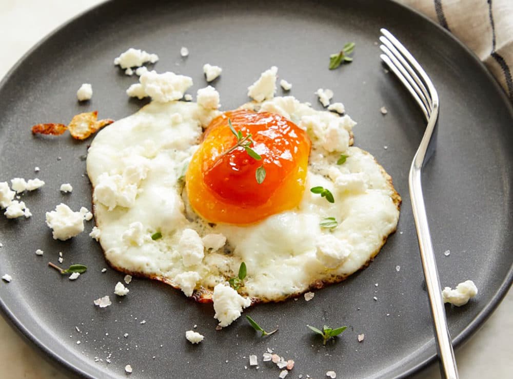 Fried eggs with apricot jam and goat cheese from "The Fresh Eggs Daily Cookbook" by Lisa Steele. (Tina Rupp)