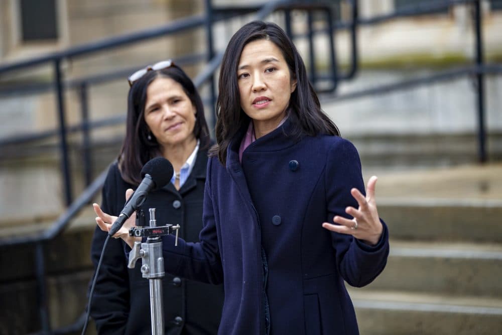 Mayor Michelle Wu speaks to the news media during a press conference at Brighton High School where Boston Public Schools Superintendent Brenda Cassellius (left) announced she would resign at the end of the 2021-2022 school year. (Jesse Costa/WBUR)
