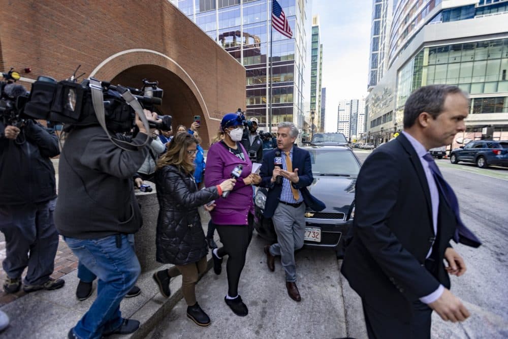 Monica Cannon-Grant is surrounded by news media as she leaves the Moakley Courthouse after her arraignment in federal court. (Jesse Costa/WBUR)