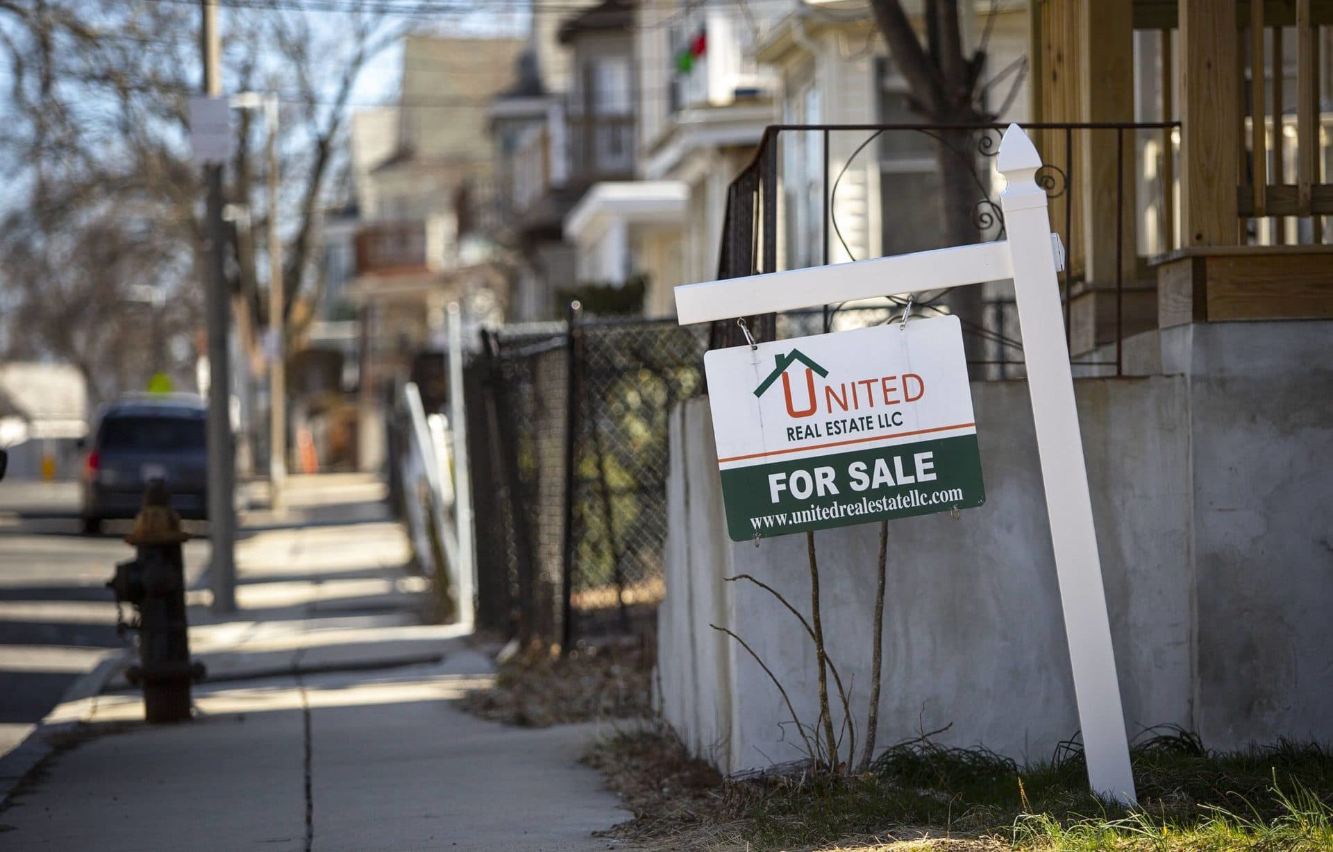 A "for sale" sign for a house on Ballou Avenue in Mattapan. (Robin Lubbock/WBUR)