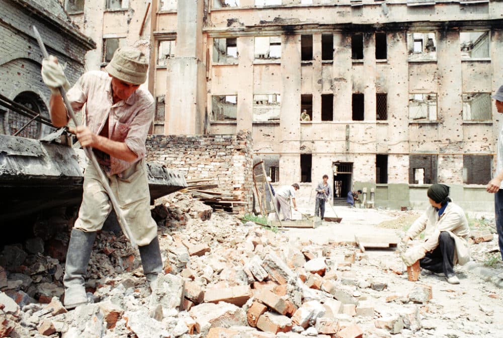 Residents of Grozny dig through rubble of destroyed buildings to salvage whole bricks to repair their destroyed houses following the siege and takeover by Russian forces this year in Grozny, May 26, 1995. (AP Photo/Sergei Karpukhin)