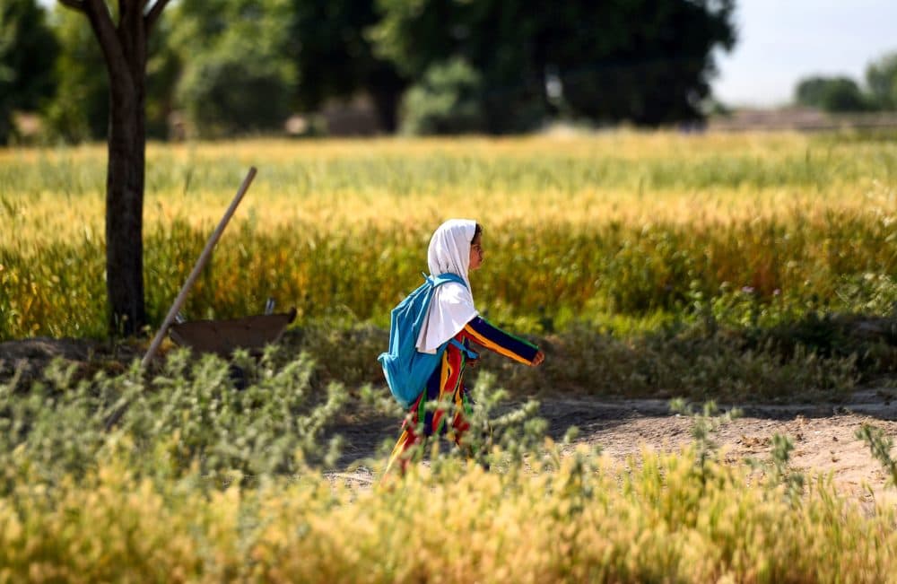 An Afghan girl walks towards her school along a field on the outskirts of Mazar-i-Sharif. (Farshad Usyan/AFP via Getty Images)