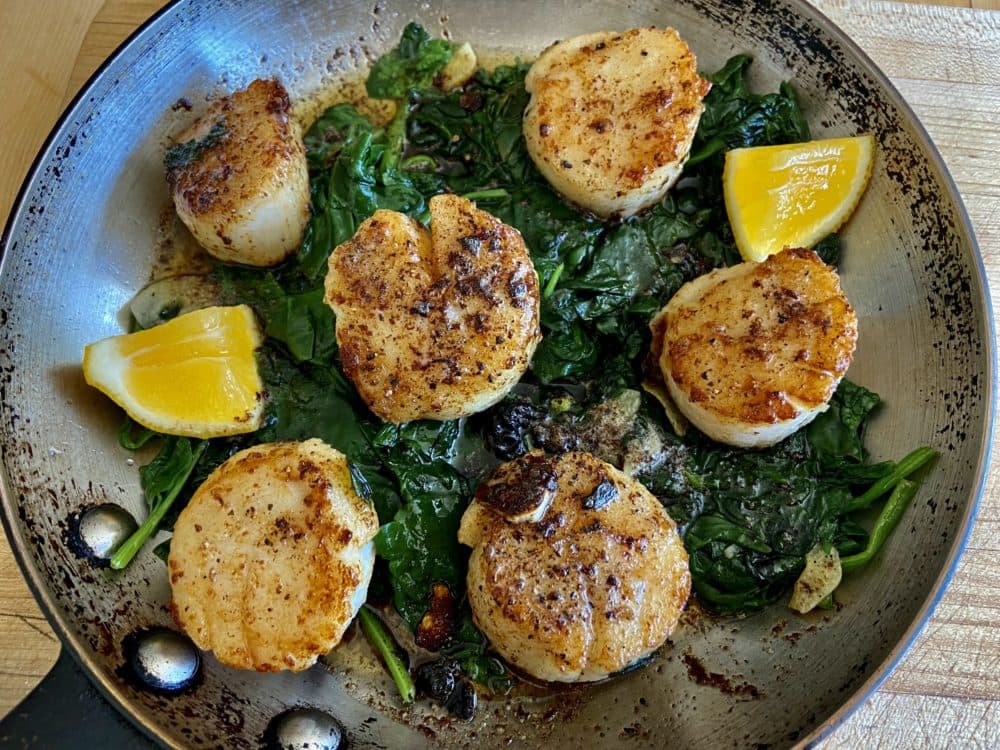 Sauteed scallops with spring spinach with brown butter-lemon sauce.  (Kathy Gunst)