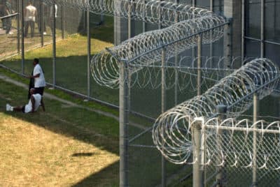 Prisoners spend time out of doors in a yard circled by concertina wire, right, at the Souza-Baranowski Correctional Center, in Shirely, Mass., Wednesday, June 30, 2004. (AP Photo/Steven Senne)