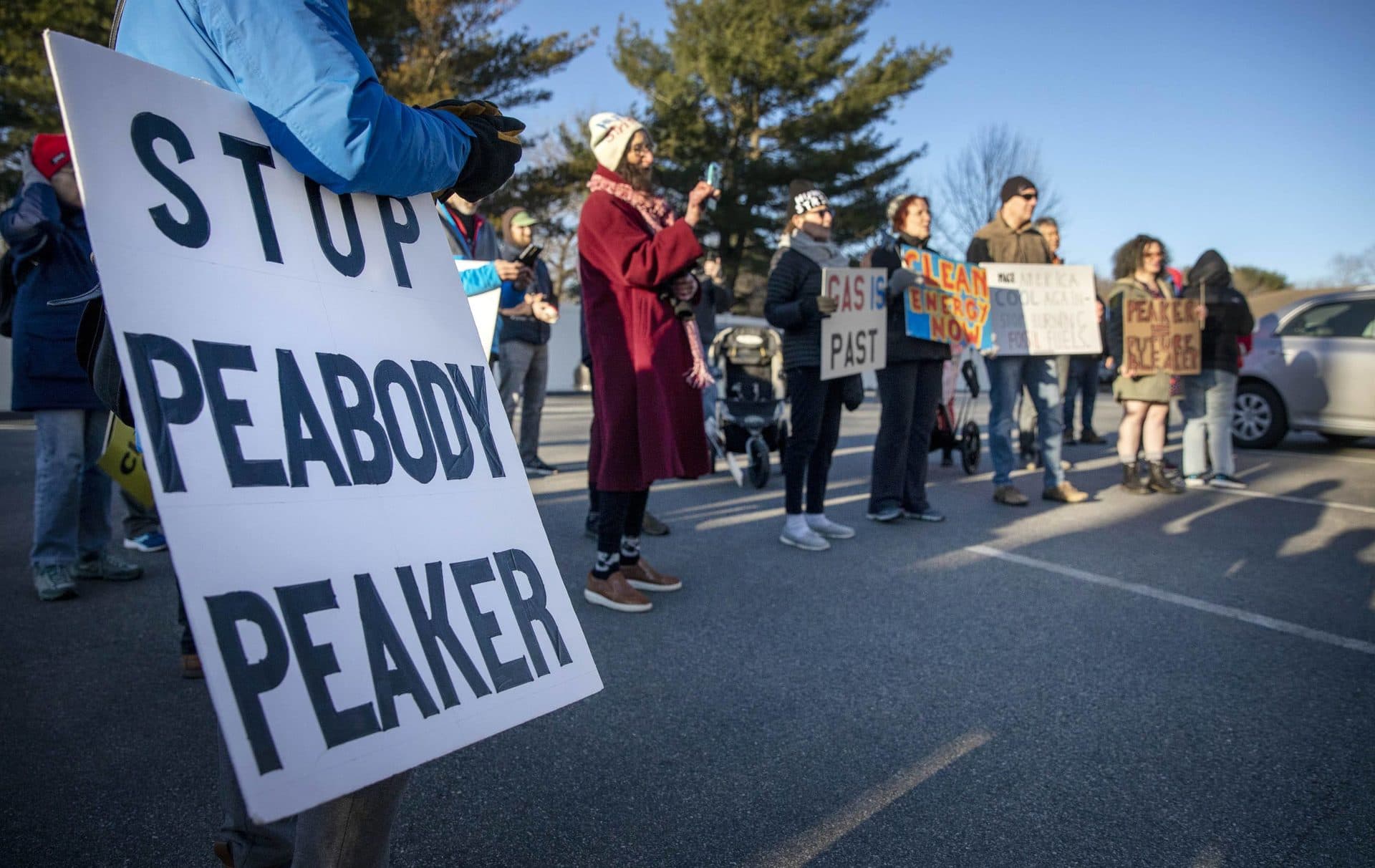 A protester displays a "Stop Peabody peaker" sign at a demonstration. (Robin Lubbock/WBUR)